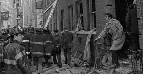 Firefighters and man at building collapse.