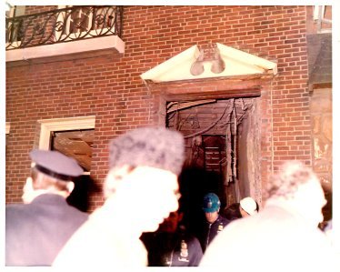 A group of people standing outside of a building.